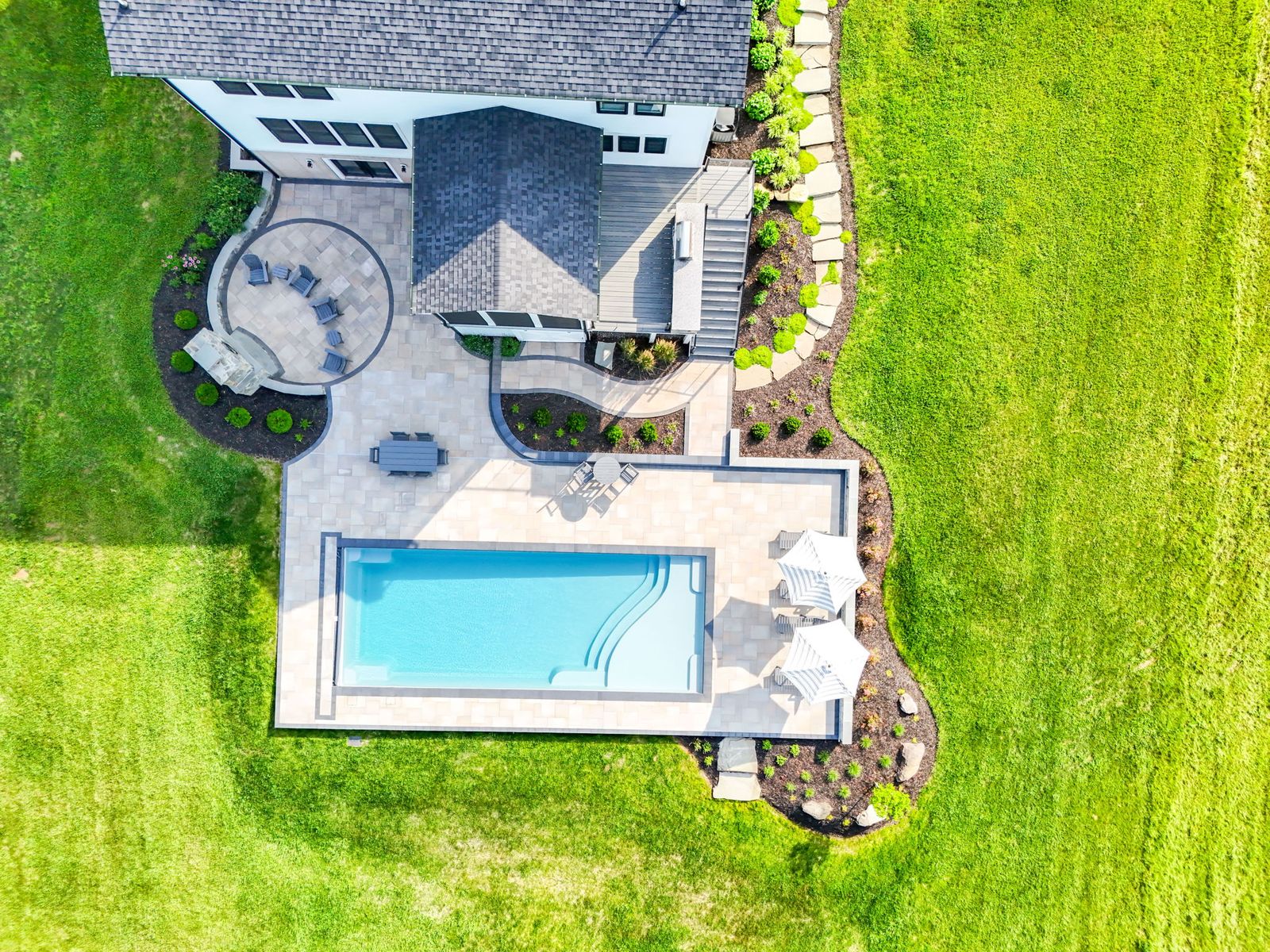 Fiberglass pool project with landscaping and hardscape terraces by Outdoor Solutions, Northern Virginia